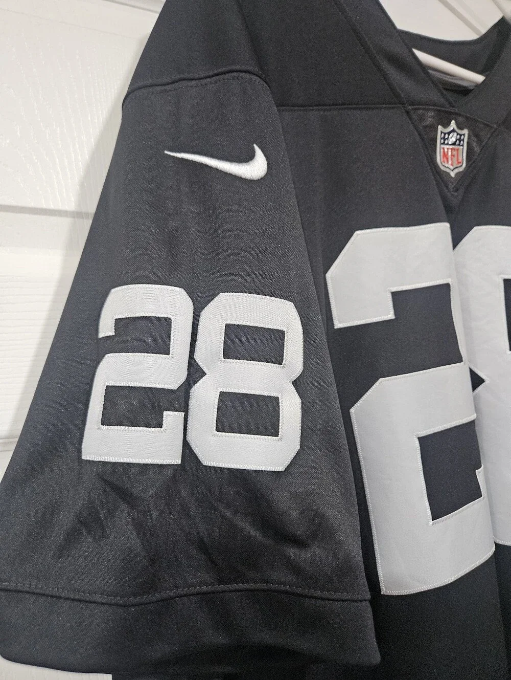 Nike Men’s Black Football Jersey with White 28 and Jacobs